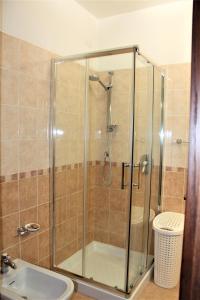 a shower with a glass door next to a sink at Villa Sofia in Taormina