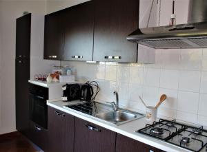 a kitchen with a sink and a stove at Villa Sofia in Taormina