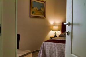 a bedroom with a bed and a mirror at Hotel Balilla in Rome