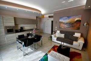 a living room with a couch and a table at I Due Grifoni Apartments in Taormina