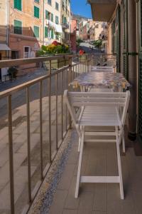 a table and chairs sitting on a balcony at Da Elisa in Riomaggiore