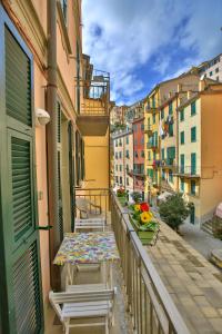 a balcony with a table and chairs and buildings at Da Elisa in Riomaggiore