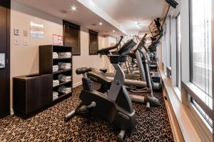 a gym with tread machines in a room at Le St-Martin Hotel Centre-ville – Hotel Particulier in Montreal