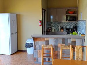 a kitchen with a counter and a refrigerator at Sunset Lane in Laborie