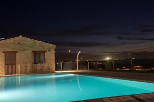a swimming pool at night with a view at Agricampeggio Abbruzzetti in Marina Palmense