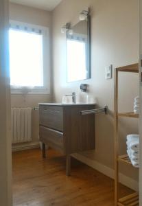 La salle de bains est pourvue d'un lavabo et d'un miroir. dans l'établissement Hôtel Le Poulmic, à Lanvéoc