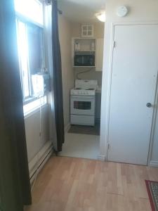 a kitchen with a white stove and a door at Alisa Guest Suites in Toronto