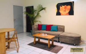 a living room with a couch and a table at Tropical Breeze Apartments in Paramaribo