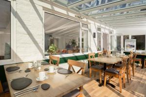 a dining room with wooden tables and chairs at Chillington House in Kingsbridge