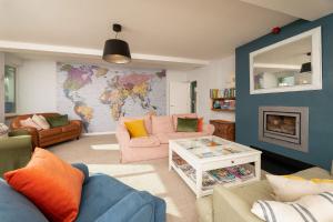 a living room with a map of the world on the wall at Chillington House in Kingsbridge