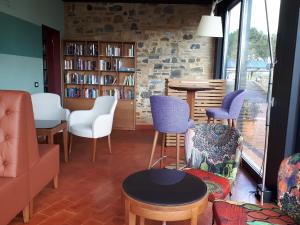 a living room with chairs and a table at Hapimag Resort Tonda in Montaione