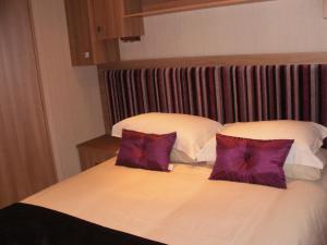 two pillows on a bed in a hotel room at Chalet 10 Dornoch Pitgrudy in Dornoch