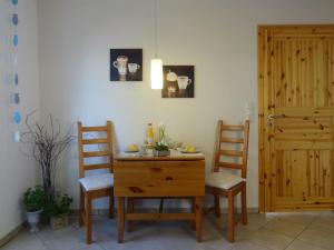 a dining room with a table and two chairs at Land & Meer in Hasselberg