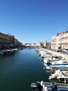 a group of boats are docked in a canal at 483 Chemin de Saint-Clair in Sète +14 photos