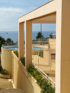 a view of the pool from the balcony of a resort at 483 Chemin de Saint-Clair in Sète