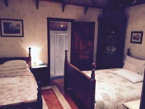 a bedroom with a bed and a door to a room at Teresas Cottage in Donegal
