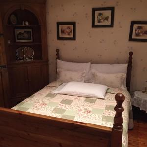 a bedroom with a bed with a quilt on it at Teresas Cottage in Donegal