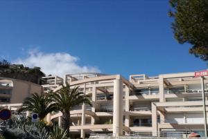 a white building with palm trees in front of it at 483 Chemin de Saint-Clair in Sète