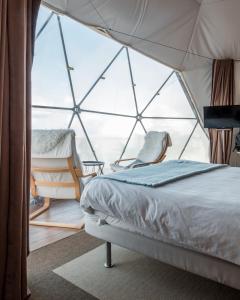 Uma cama ou camas num quarto em Natura Glamping