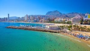 an aerial view of a beach with people in the water at Sunset Drive by Albamar in Benidorm