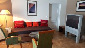 a living room with a bed and a tv at Lipno Apartmany Frymburk III. in Frymburk