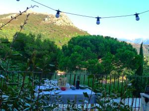 a table with a bottle of wine sitting on a balcony at A ChiOsella in Corbara