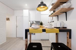 cocina con mesa y mantel amarillo en Cozy Apartment Salamanca Neighborhood en Madrid