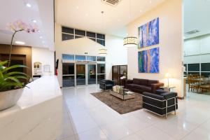 a living room with a couch and a table at Matiz Barão Geraldo Express Hotel in Campinas