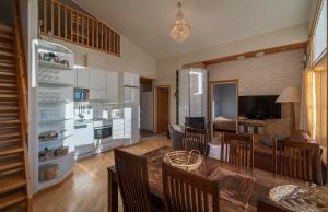 a kitchen and living room with a table and chairs at Kiisa A and B with aurora rooms in Saariselka