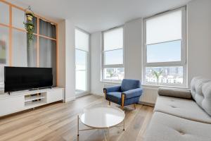 Televízia a/alebo spoločenská miestnosť v ubytovaní Platinium Top Floor City View