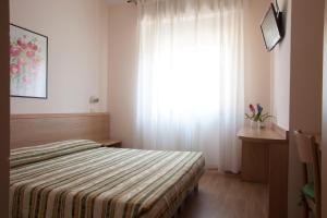 Postel nebo postele na pokoji v ubytování Hotel Cecco