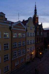 a large building with a clock tower in a city at Elite Apartments Old Town Premium in Gdańsk