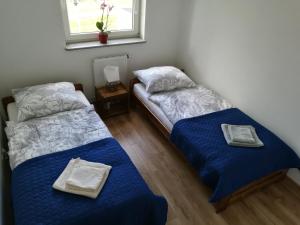 Rúm í herbergi á GM Apartament Szczecin