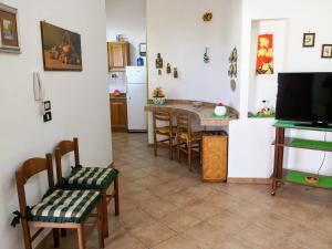 a kitchen and dining room with a table and chairs at Paradise House in Alcamo Marina
