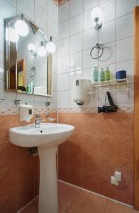 a bathroom with a sink and a mirror at ReHouse- Zemaitijos 11 in Vilnius