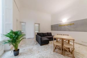 a living room with a couch and a table at Macchia Mediterranea Guest House in Bari
