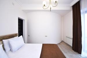 Voodi või voodid majutusasutuse Patriott Hotel toas