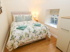 a bedroom with a bed and a window at The Loft Apartment in Todmorden