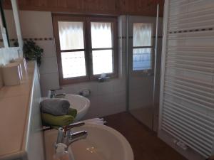 a bathroom with a sink and a toilet and a window at Ferienwohnung Bolsterlang in Bolsterlang +14 photos
