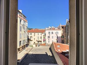 a view from a window of a street with buildings at Studio Vagliano in Cannes