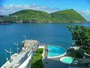 a swimming pool in the middle of a body of water at apartamento cinco reis in Angra do Heroísmo