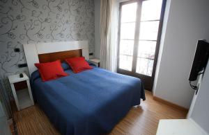 Postel nebo postele na pokoji v ubytování Hostal Centro