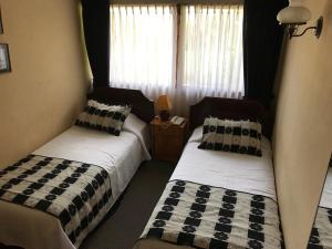 Letto o letti in una camera di Hotel Luanco