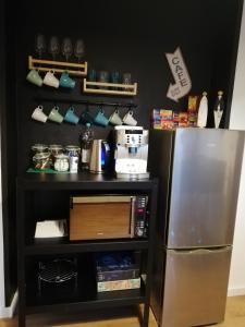 a kitchen with a refrigerator next to a shelf at Dream & Relax Apartment's Messe in Nürnberg