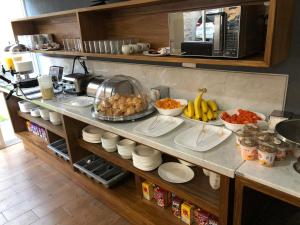 a kitchen counter with plates of food on it at Eco Hotel Guadalajara Expo in Guadalajara