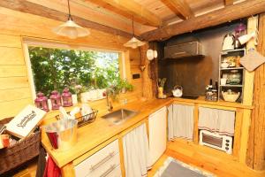 a kitchen with a sink and a window in a cabin at Ribeira Delos in Santa Marta de Penaguião