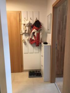 a room with a refrigerator and a shelf with bags at Apartmán Čihadla in Bedřichov