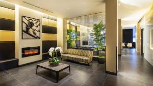 a lobby with a couch and a fireplace at The Hotel at Fifth Avenue in New York +48 photos