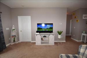 a living room with a flat screen tv on a table at 113 Cypress Bend Condo in North Myrtle Beach +8 photos