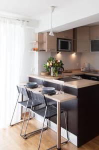 a kitchen with a island with chairs and a table at Homz AH02 Kolonaki Penthouse Studio in Athens